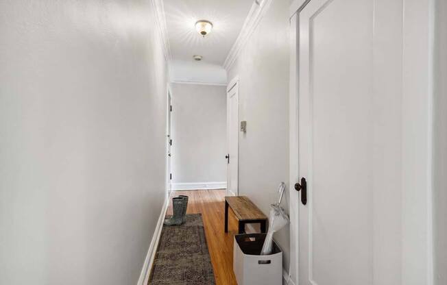 a hallway with white walls and a wooden floor at The Bryant at Oak Park I & II, Oak Park Illinois