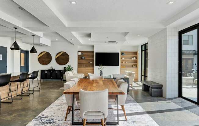 a dining room and living room with a wooden table and chairs