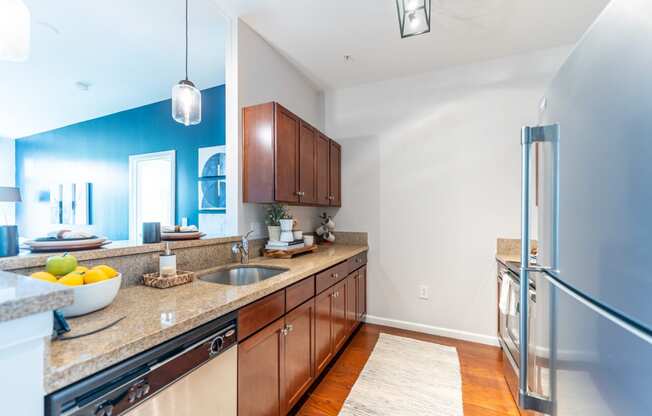 a kitchen with wood cabinets and granite countertops