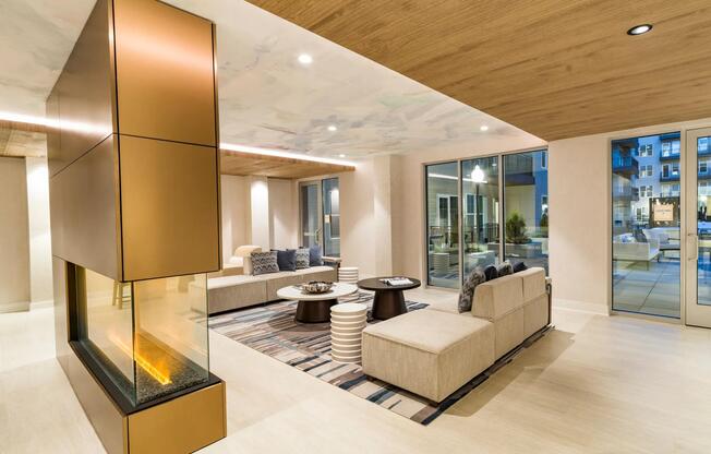Gather in the elegant lounge at Modera Liberty Row, featuring a sleek fireplace and inviting seating just minutes from Uptown Charlotte.