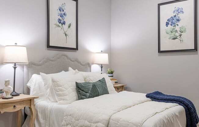A bedroom with a white bed and a brown rug.