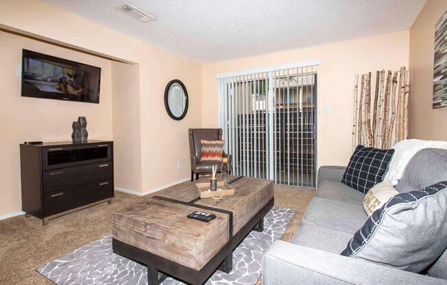 a living room filled with furniture and a flat screen tv