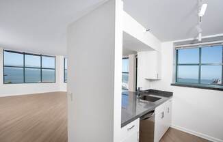 A kitchen with a large island and a view of the water.