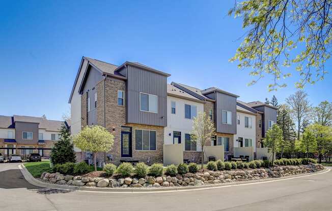 - Maple Place Apartments - a row of apartment buildings with a street in front of them