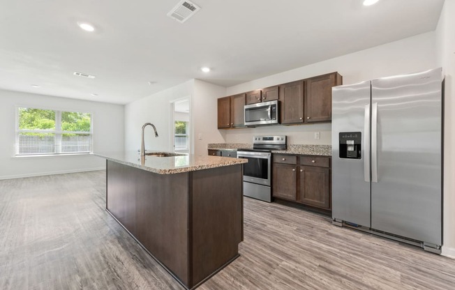 a kitchen with stainless steel appliances and a marble counter top