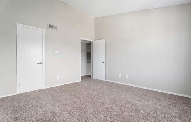 A room with carpeted floor and white walls.