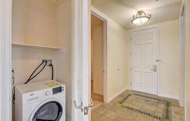A small laundry room with a washer and dryer.