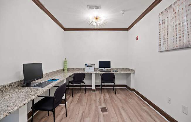 A room with a desk and chairs.