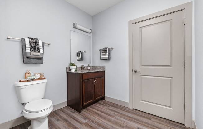 a bathroom with a toilet and a sink and a door