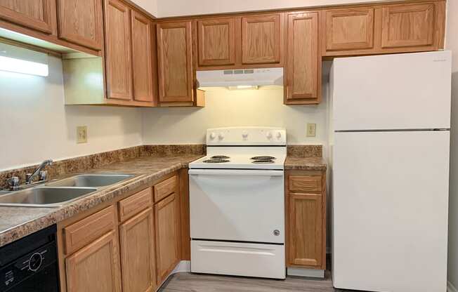 Modern kitchen with faux plank flooring at Waterstone Place Apartments in Indianapolis, IN 46229