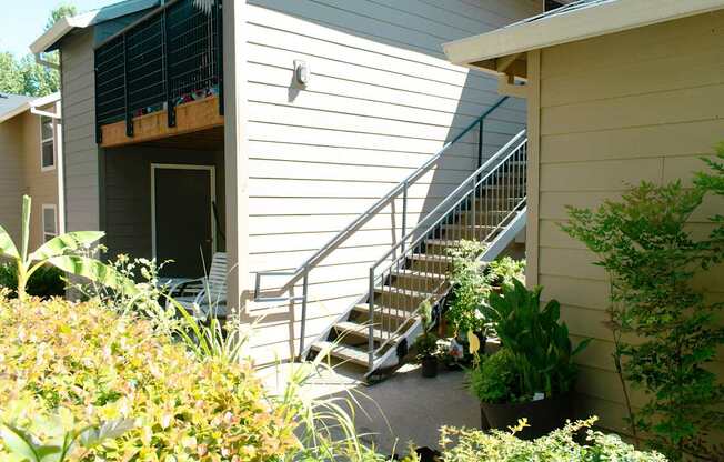 A staircase leads up to a balcony on a house.