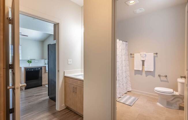 A bathroom with a toilet, sink, and shower at Forestplace Apartment Homes, Forest Grove, OR, 97116