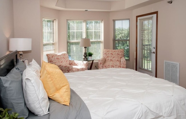 master bedroom with bay windows and patio