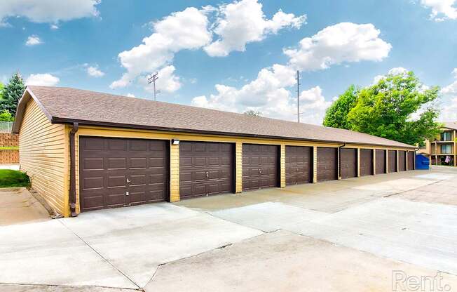 a row of garages in front of a parking lot