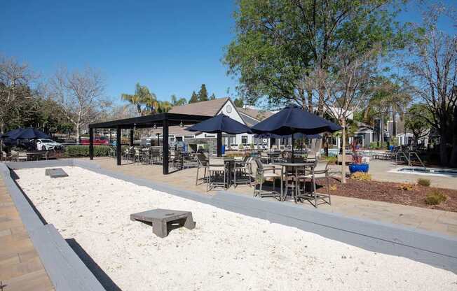 A sandy area with a pavement and a few chairs and tables at Kirker Creek Apartments, Pittsburg, CA, 94565
