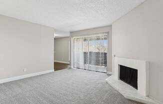 A room with a fireplace and a window with blinds.