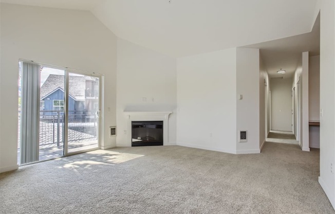 a living room with a fireplace and a sliding glass door