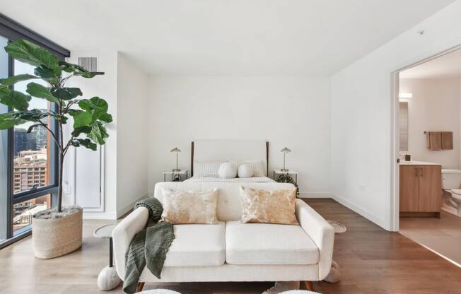 a bedroom with a couch and a bed and a large window at Cassidy on Canal, Chicago, IL, 60654