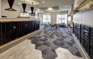 a large room with a bunch of lockers and a table with chairs at Arise Riverside, Austin, 78741