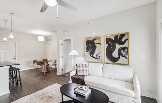 a living room with a white couch and a coffee table