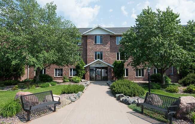 a brick building with two benches in front of it
