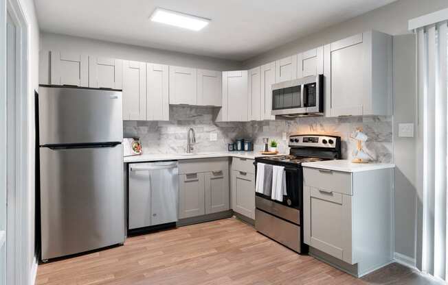 Kitchen with stainless steel appliances and shaker-style cabinets