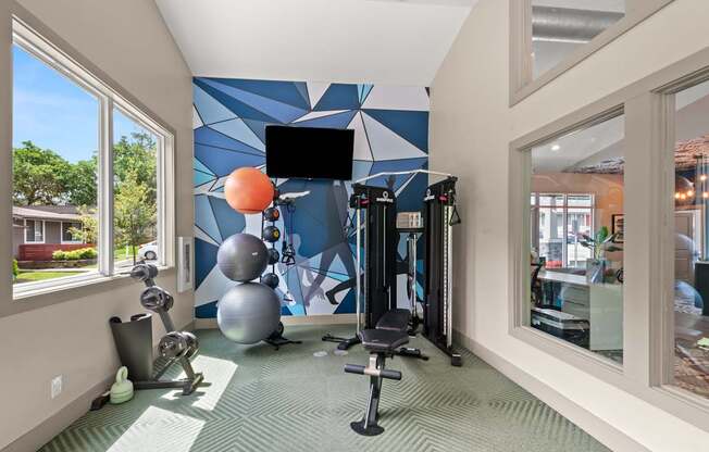 Retreat at Indian Lake Apartments Hendersonville TN gym with a television, weights, and exercise equipment.