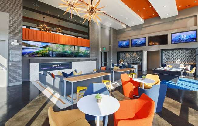 a lounge area with chairs and tables and a fireplace