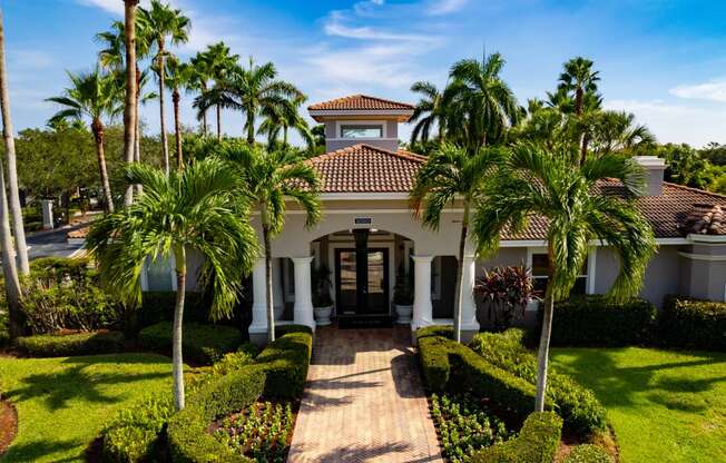 a house with palm trees in front of it at Heritage Bay, Jensen Beach, FL 34957