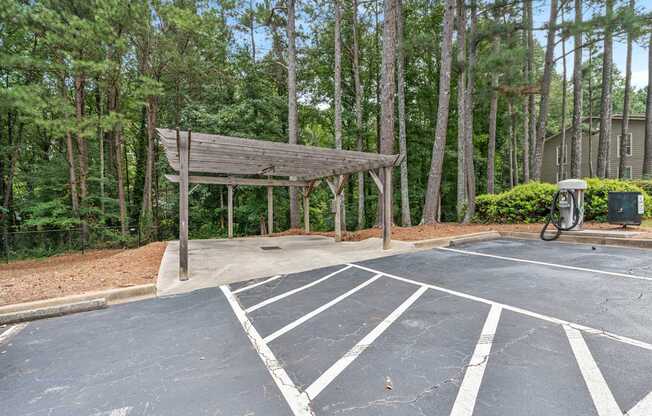 A parking lot with a wooden structure in the middle.
