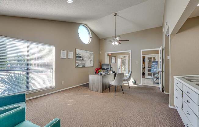 A room with a desk and a chair in it.