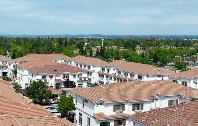 A view of a residential area with houses and trees.