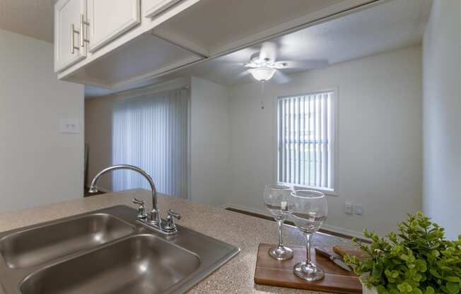 This is a photo of the dining room from the kitchen in the 871 square foot 2 bedroom, 2 bath apartment at Princeton Court Apartments in the Vickery Meadow neighborhood of Dallas, Texas.