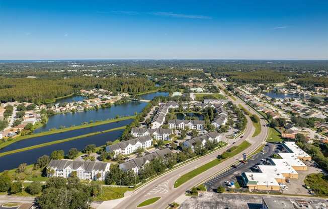 an aerial view of a city with a river and houses