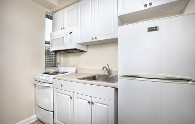 White Cabinetry And Appliances In Kitchen at Empire, Washington, DC, 20006