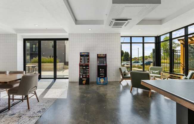 a lounge area with chairs and tables and vending machines