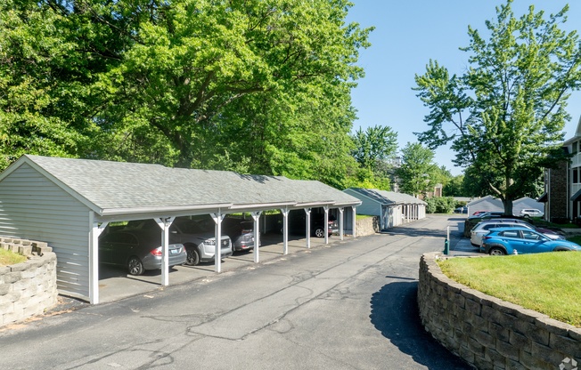 a parking lot with cars parked in front of a garage