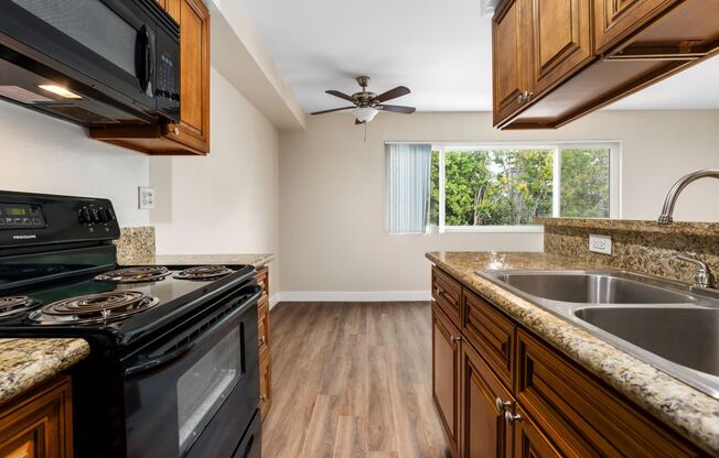 a kitchen with a stove top oven next to a sink