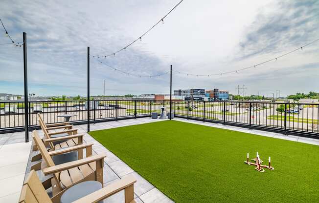 the rooftop patio with lawn chairs and a view of the city at The Standard on 32nd, West Fargo