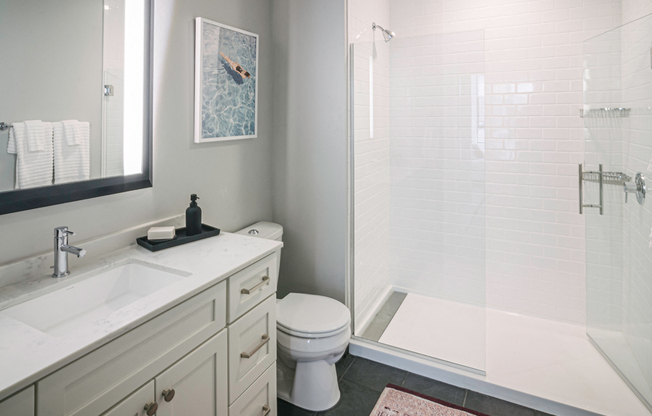 Quarter baths feature a glass shower enclosure and subway tile