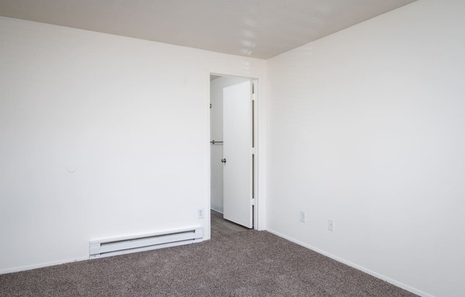 a bedroom with a carpeted floor and white walls