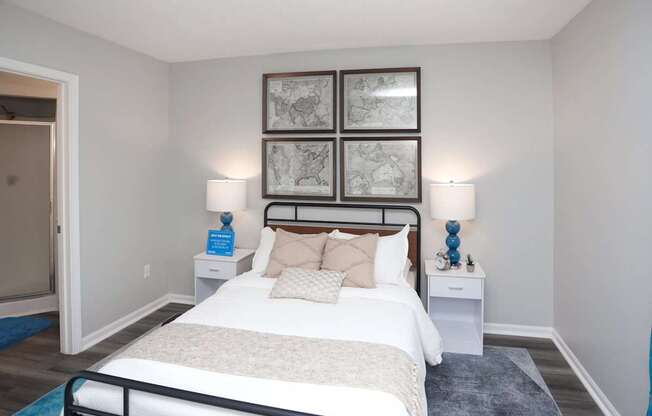 A bedroom with a large bed and a white nightstand.