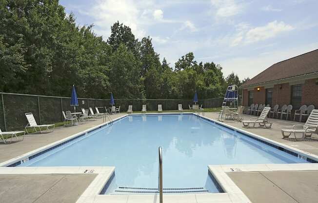 Beautiful private swimming pool with lounge chairs at Spring Hill Apartments & Townhomes, Baltimore