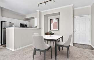 A kitchen with a table and chairs in the middle of the room.