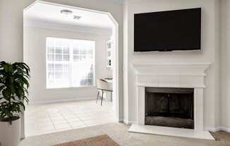 a living room with a fireplace and a tv above it