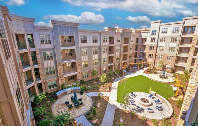 an aerial view of an apartment complex with a playground and fountain at Artesia Big Creek, Alpharetta, GA, 30005