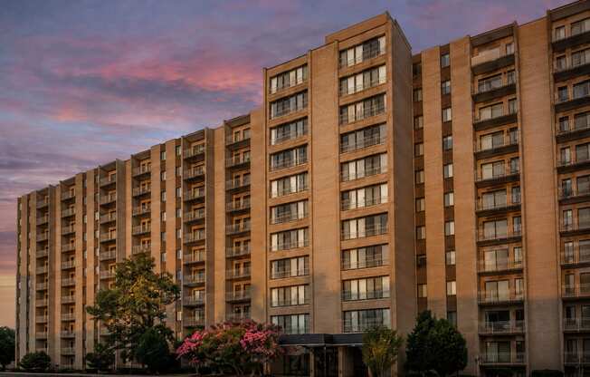 A large apartment building with balconies and windows is shown.