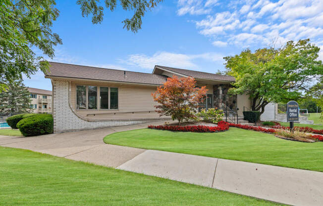 the front of a house with a yard and grass