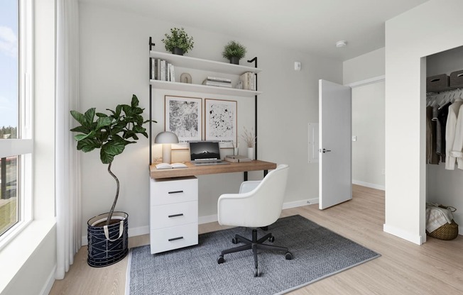 A white desk with a chair and a potted plant in a room.