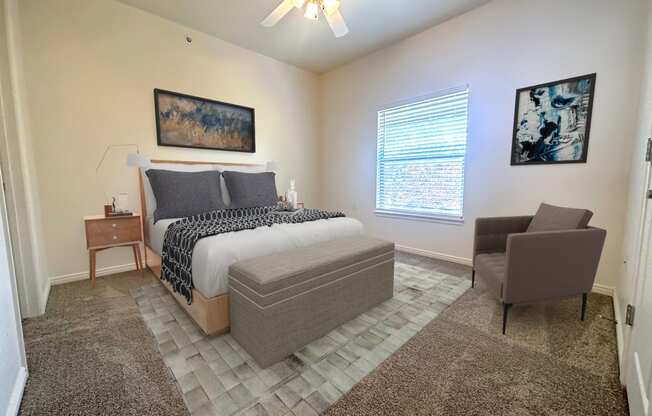 Liberty Landing Apartments Heathrow Floor Plan double bed with night table and chair. West Jordan, Utah.